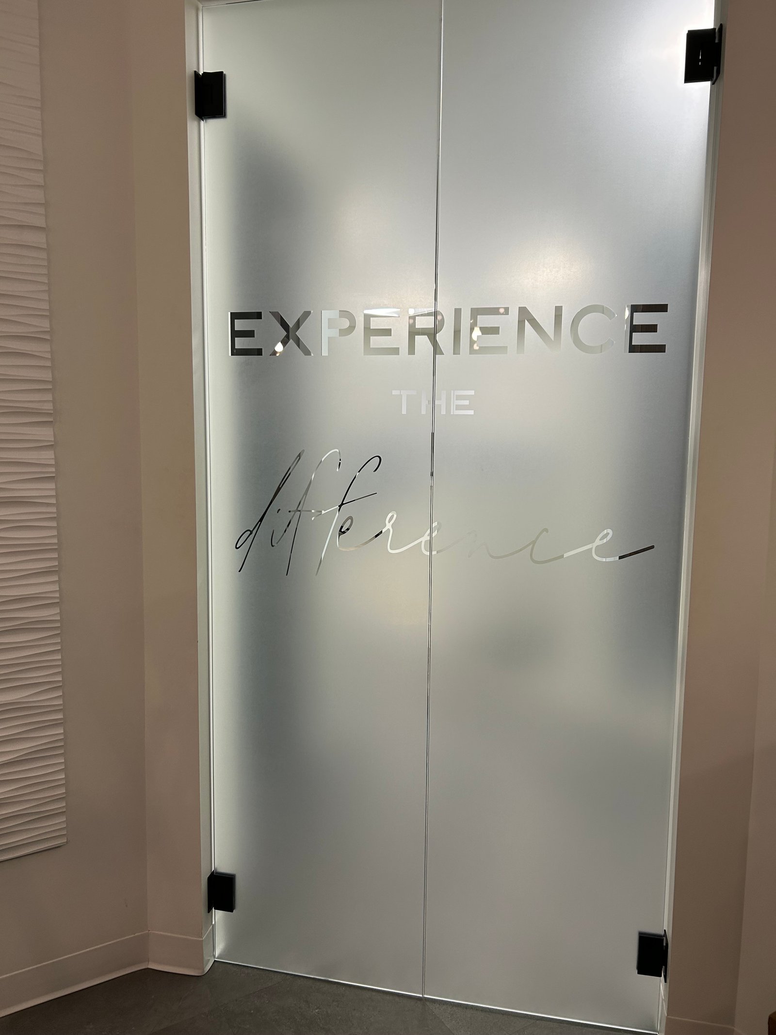 Experience the Difference frosted glass wall accent